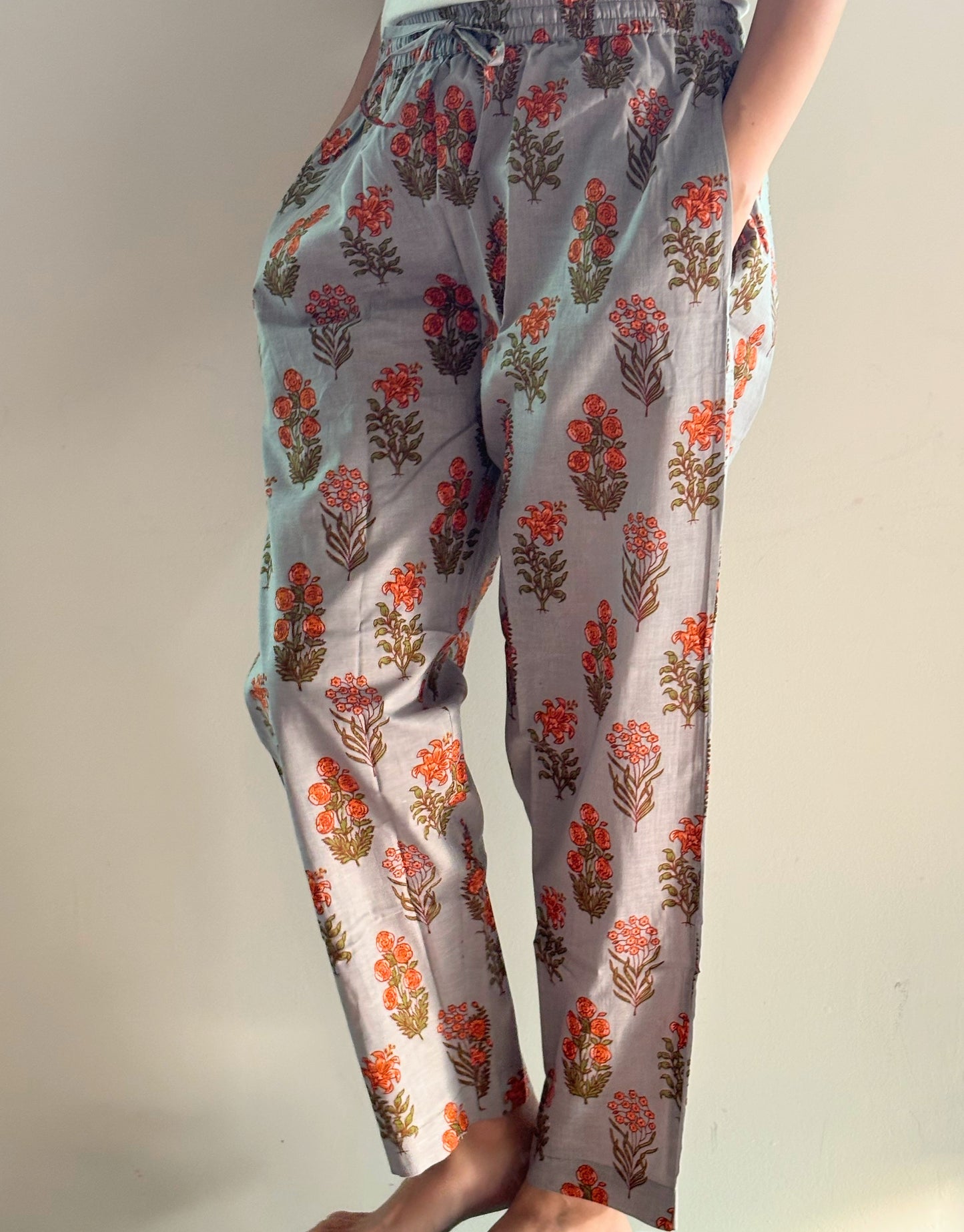 Relaxed fit pajama bottoms for bridesmaids in soft cotton with a tropical orange flower design, elastic waist, and drawstring, ideal for getting ready on the big day.