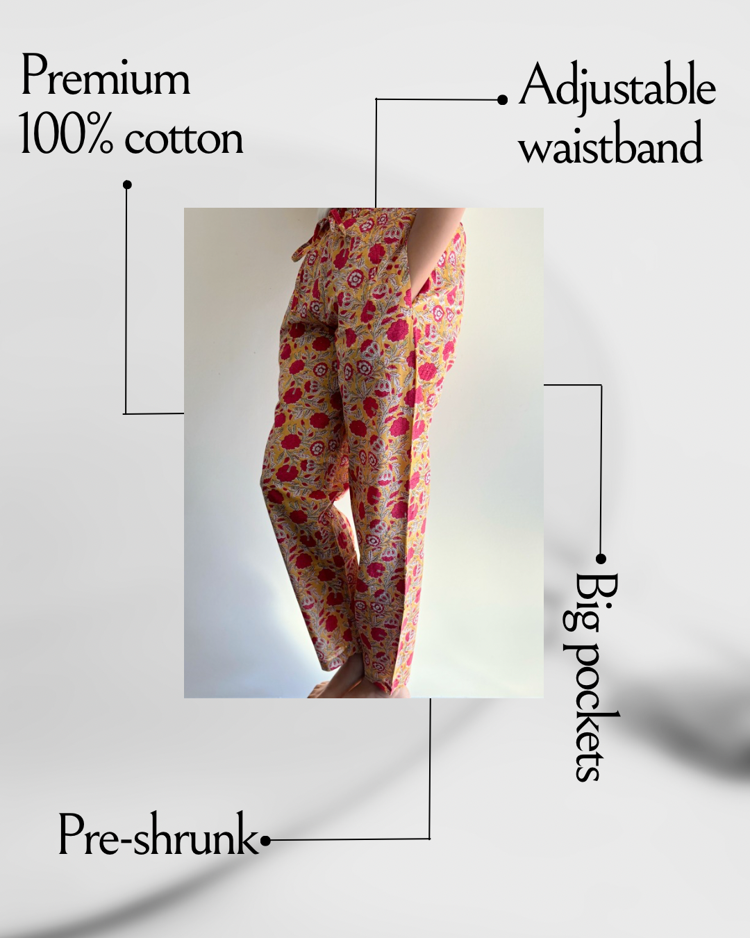 Women's cotton pajama pants featuring pink flowers on a bright yellow background. Designed with pockets and an easy fit, perfect for lounging at home.