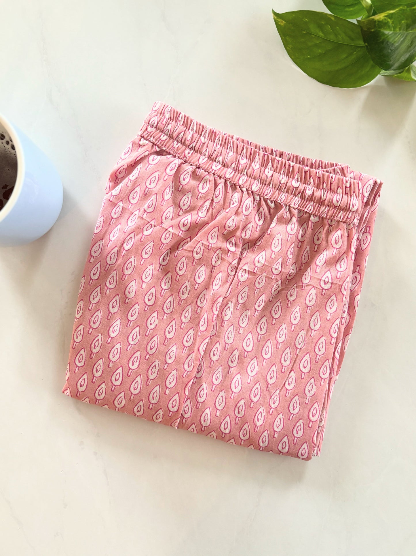 Relaxing lounge pants for women, designed with a soft cotton fabric and a charming white tree print on pink, perfect for comfortable sleep or casual lounging.