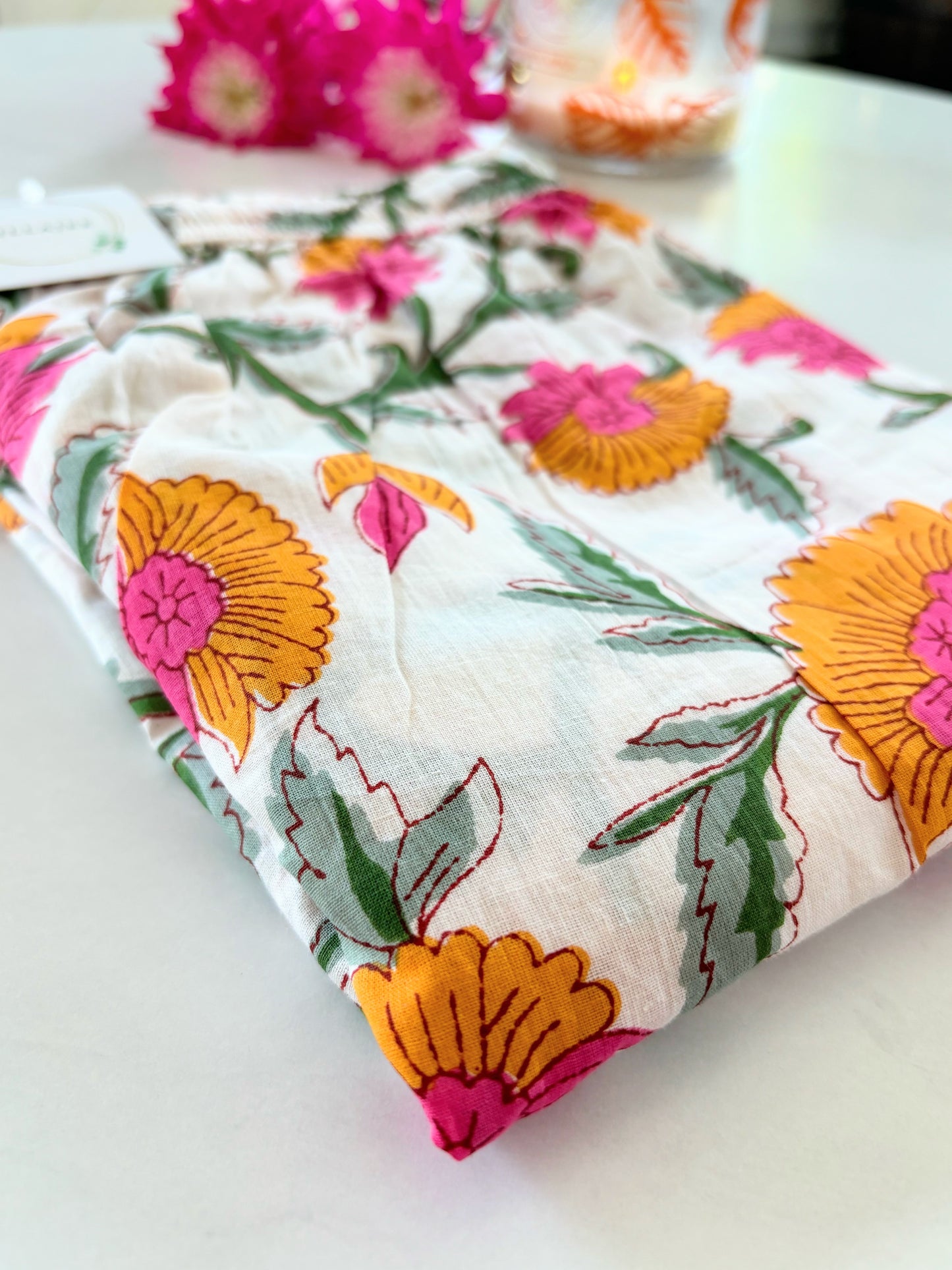 White cotton pajama pants for women with pink and orange floral print and functional pockets