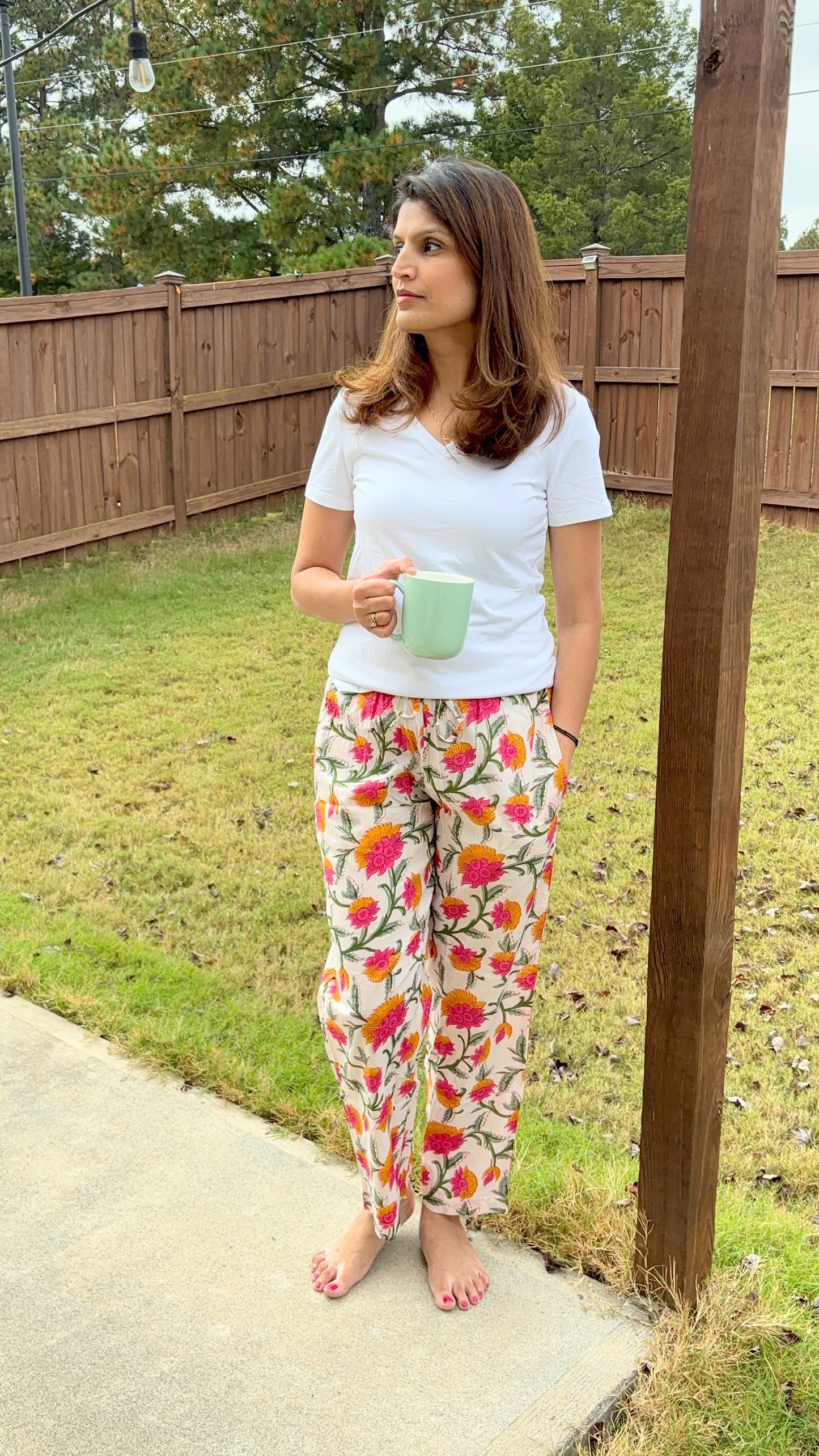 Floral cotton lounge pants for women with pink and orange flowers, elastic waist, and pockets