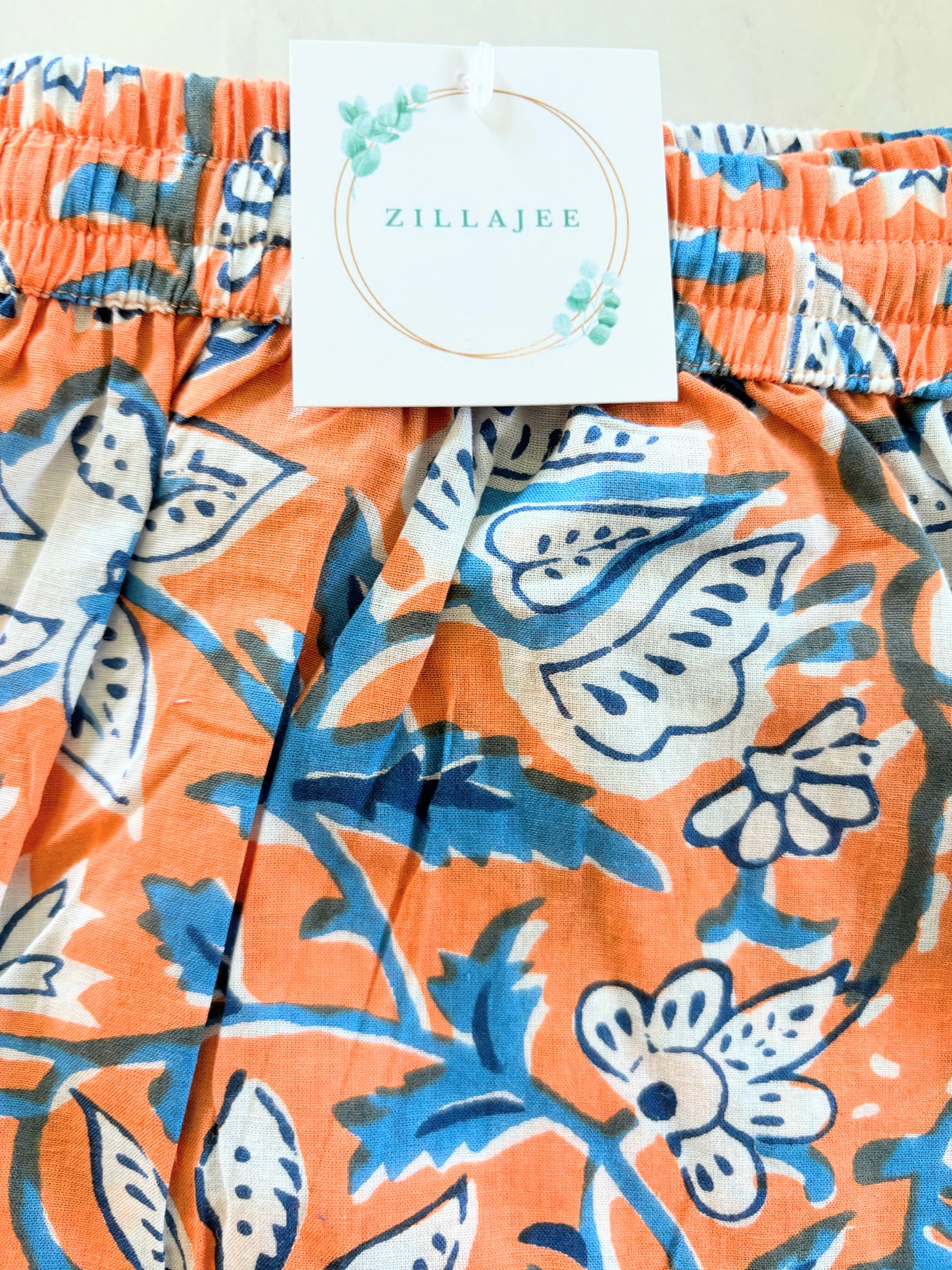 Floral print pajama bottoms for females, with an orange and green design, ideal for breathable comfort and relaxation at home.