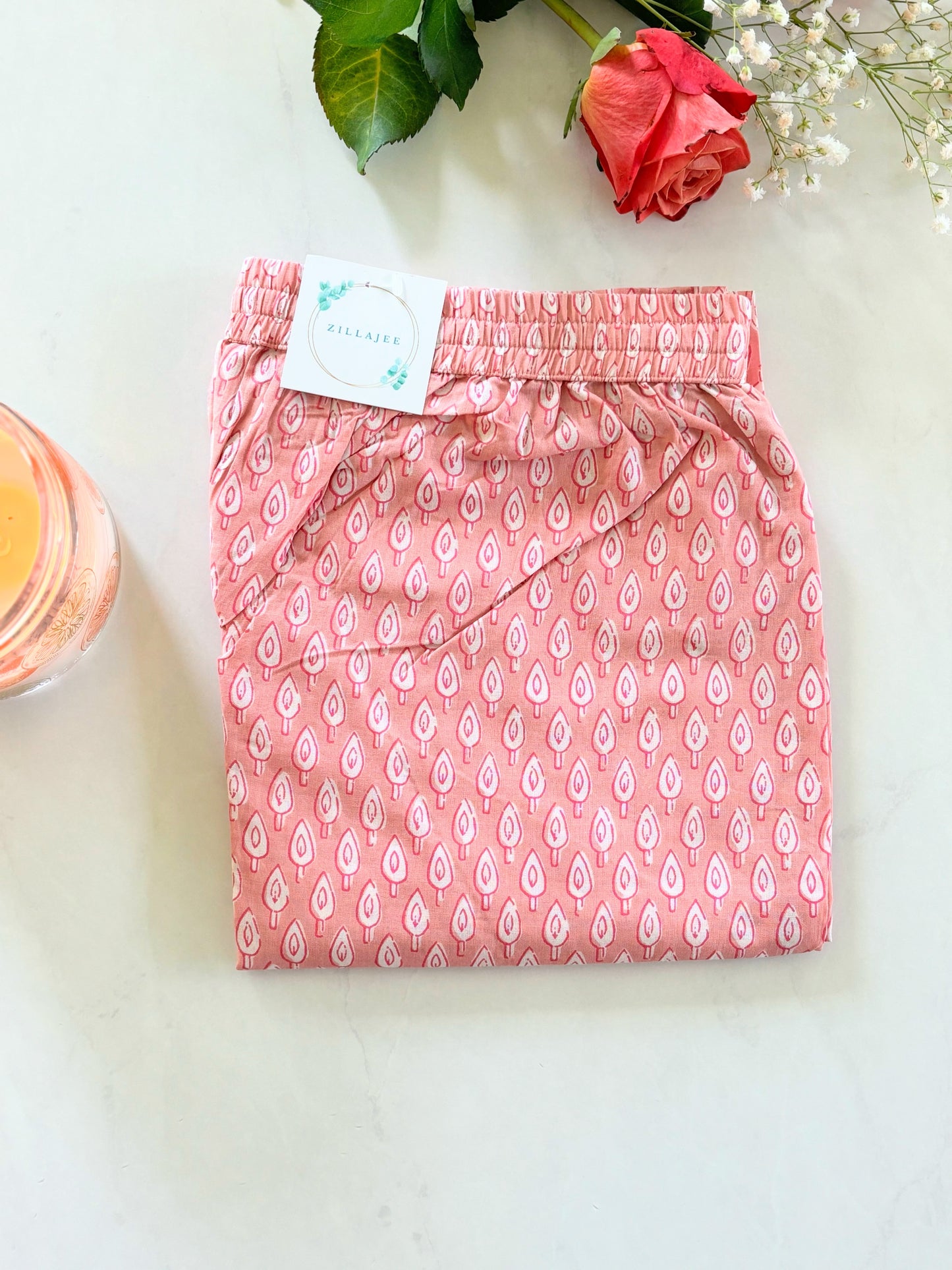 Stylish women's lounge pants with a playful white tree print on pink, crafted from soft, breathable cotton to keep you comfortable all night long.