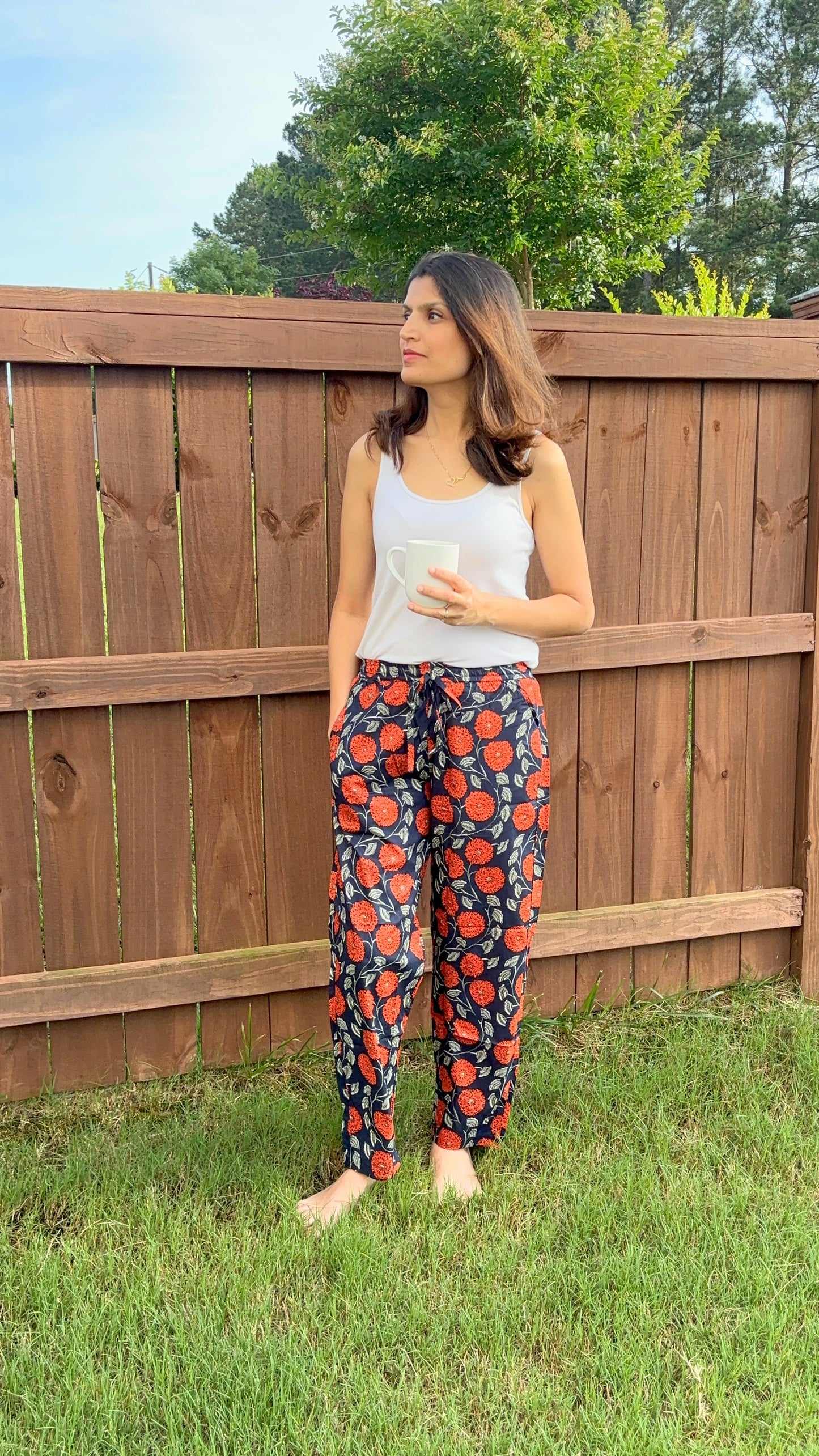 Stylish and cozy 2-pack pajama pants for women, made from 100% cotton: one with a playful red floral print on yellow, and another with a soothing orange floral pattern on navy.