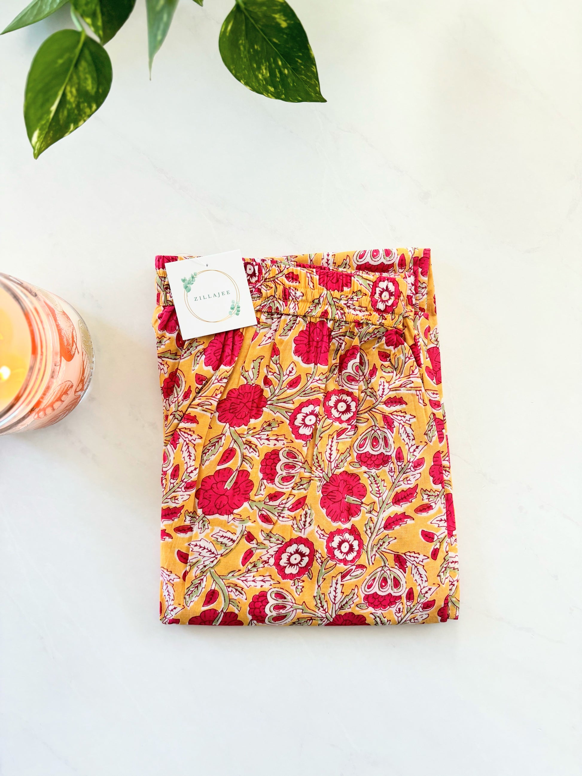 Relax in style with this 2-pack of cotton pajama pants for women: one pair featuring a bright yellow background with red flowers, and another with a deep navy blue background and orange flowers.