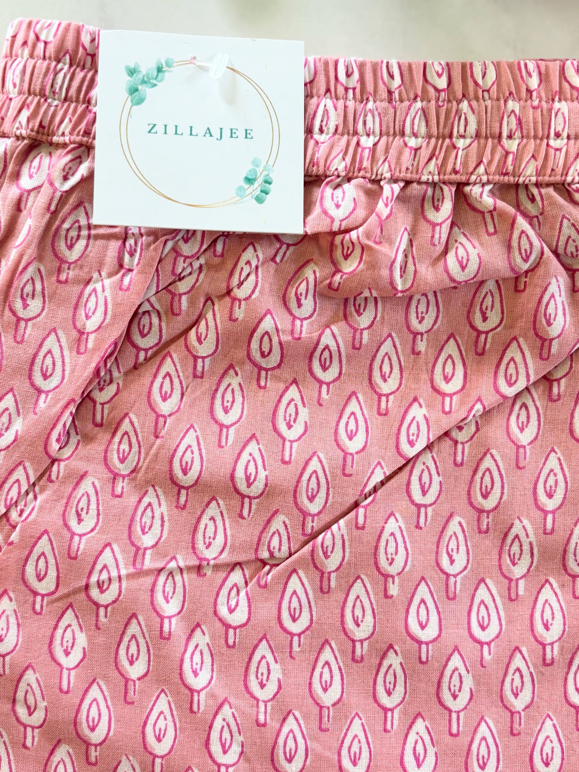 Breathable women’s sleepwear featuring soft pajama pants with a cute white tree print on pink, designed for comfort and relaxation at home.