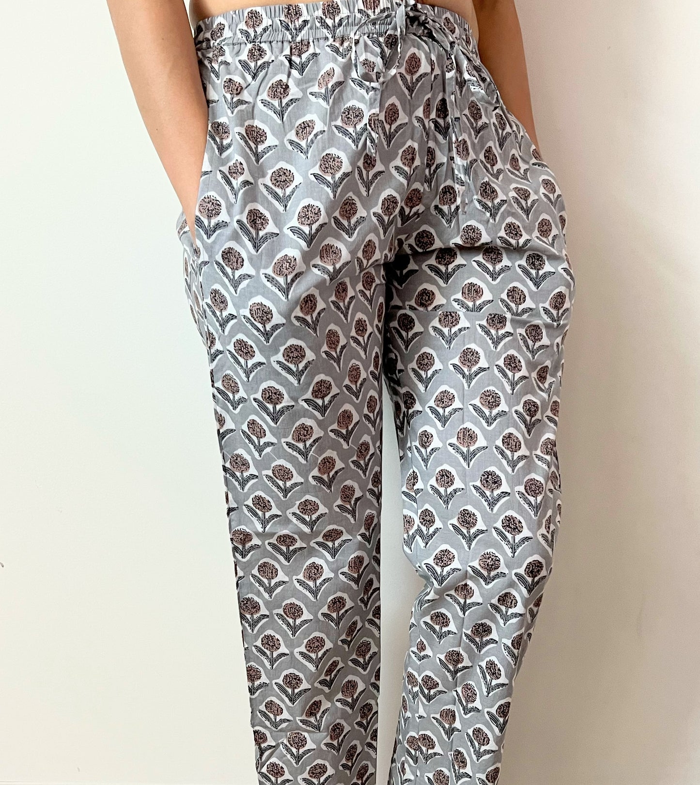 Women's floral pajama pants in 100% cotton, featuring a gray backdrop with brown and gray flowers, designed for ultimate comfort and relaxation with side pockets.