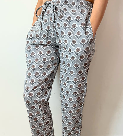 Soft and stylish cotton pajama pants for women in a floral design with brown and gray flowers, set against a gray background, perfect for lounging or sleeping, with pockets.