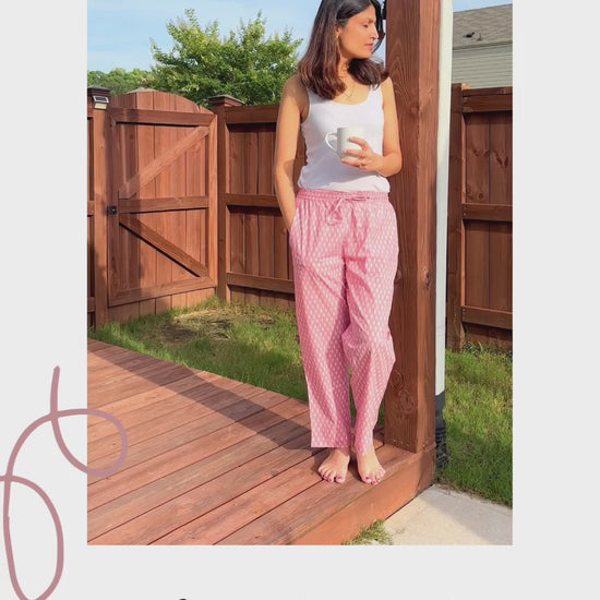 Charming sleep pants for women, designed with a soft cotton fabric and a whimsical white tree pattern on pink, perfect for lounging or relaxing.