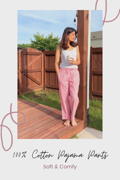 Charming sleep pants for women, designed with a soft cotton fabric and a whimsical white tree pattern on pink, perfect for lounging or relaxing.